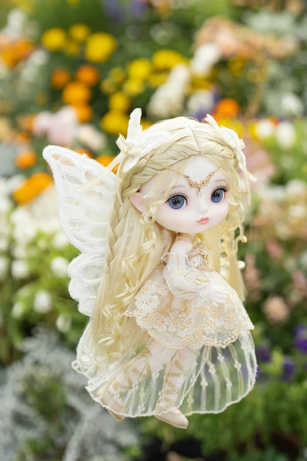 Fairy doll with wings in a garden setting
