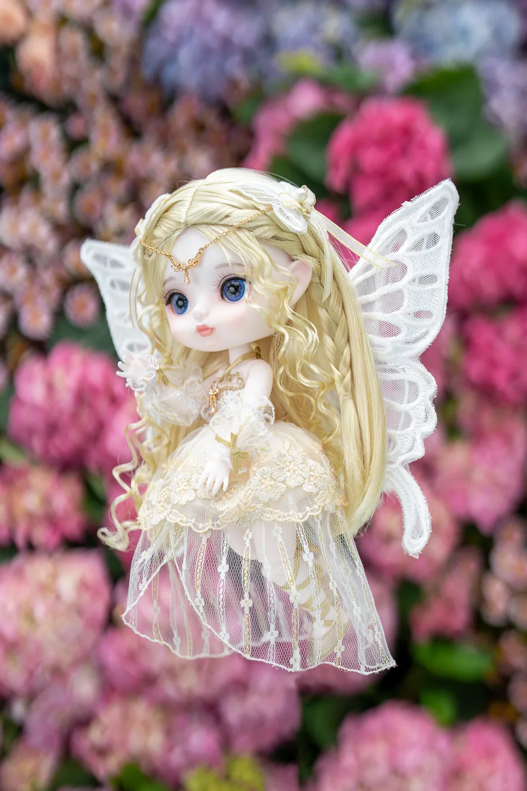 Fairy doll with wings in a garden setting