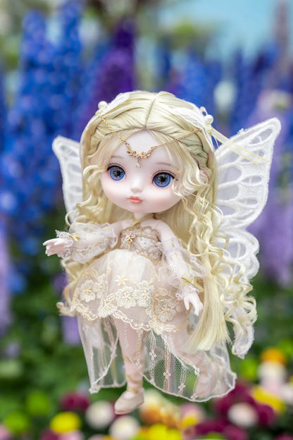 Fairy doll with wings in a garden setting