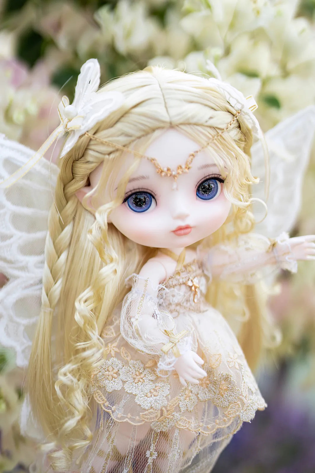 Fairy doll with wings in a garden setting