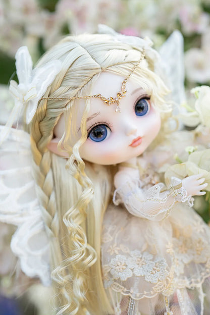 Fairy doll with wings in a garden setting