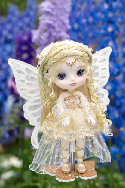 Fairy doll with wings in a garden setting