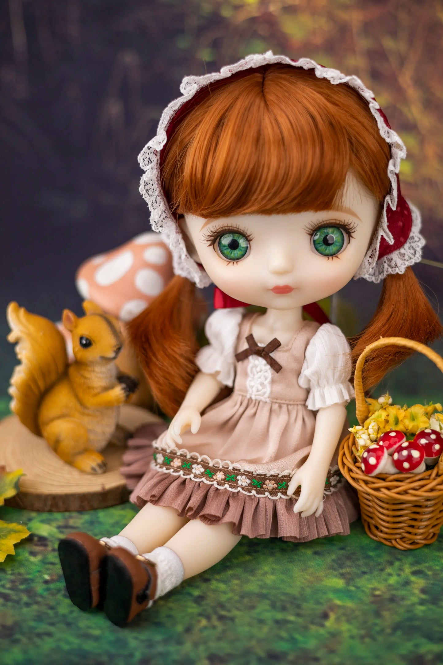 Doll with ginger hair and green eyes sitting next to a squirrel and basket of mushrooms.