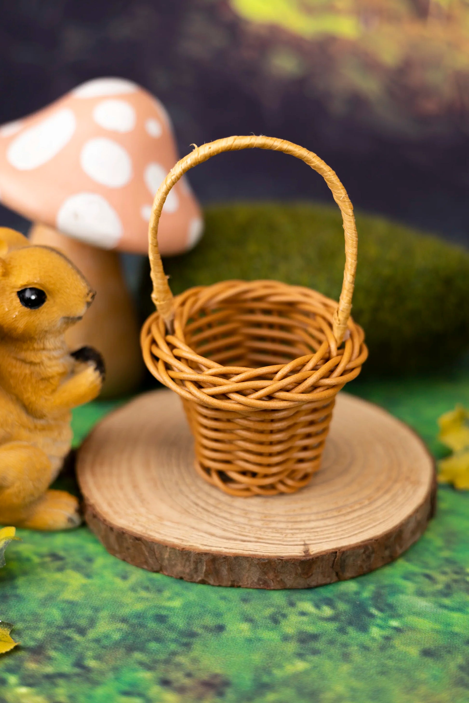 Wicker basket on a wooden log with a mushroom and animal figurine in the background