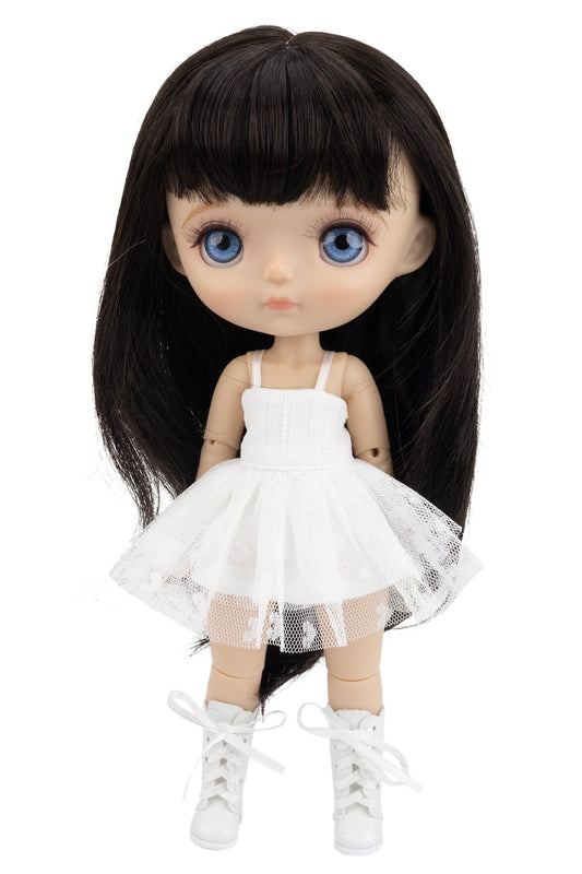 Doll with long black hair wearing a white dress on a white background