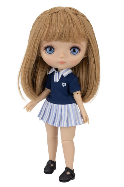 Doll wearing a navy blue top paired with a playful striped skirt.