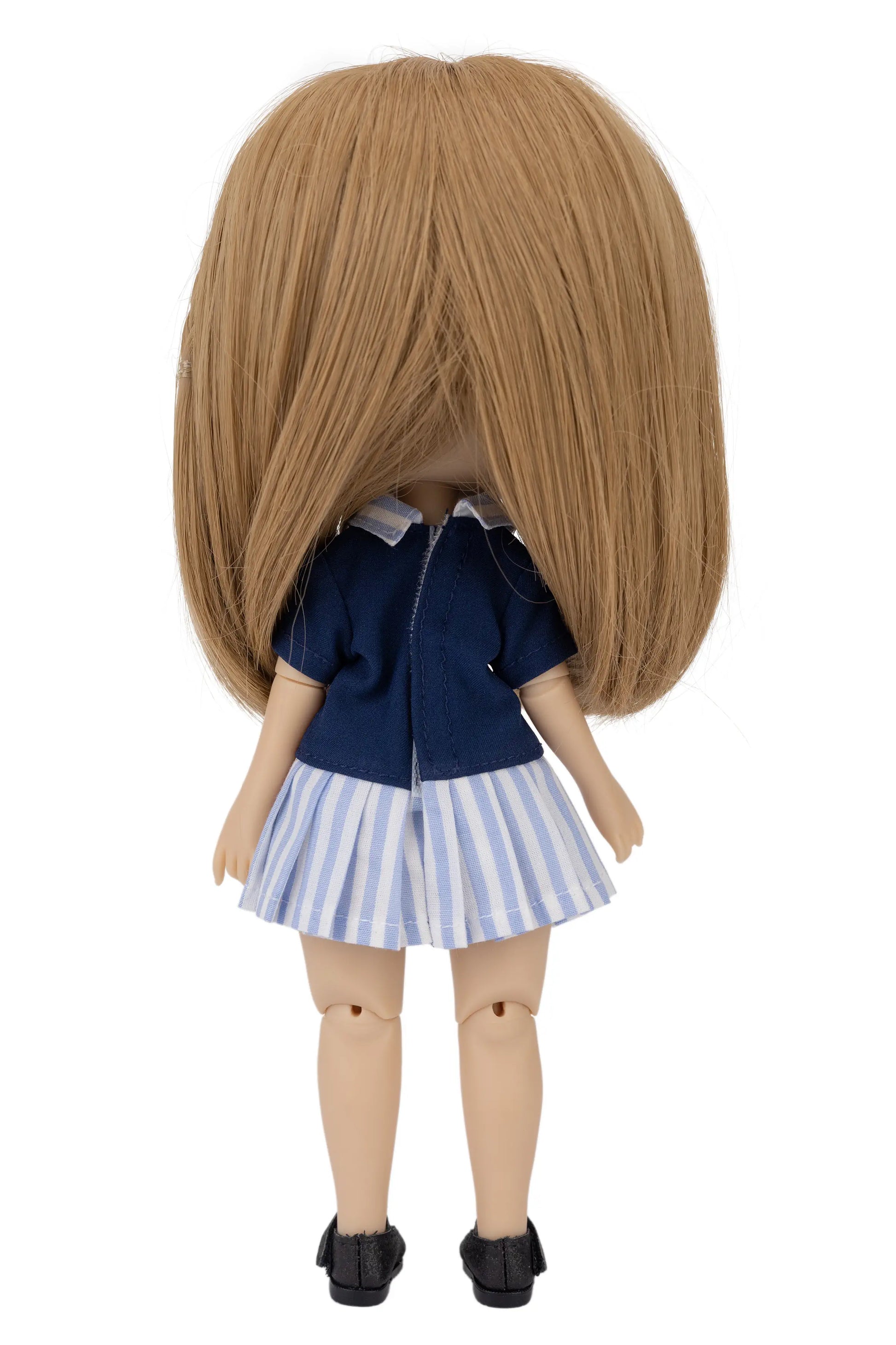 Doll with brown hair wearing a blue top and striped skirt on a white background