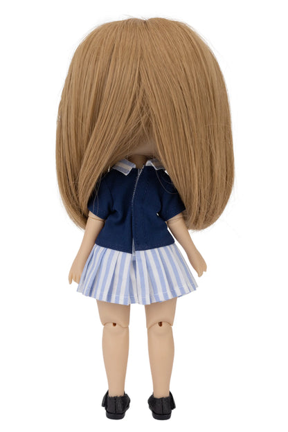 Doll with brown hair wearing a blue top and striped skirt on a white background