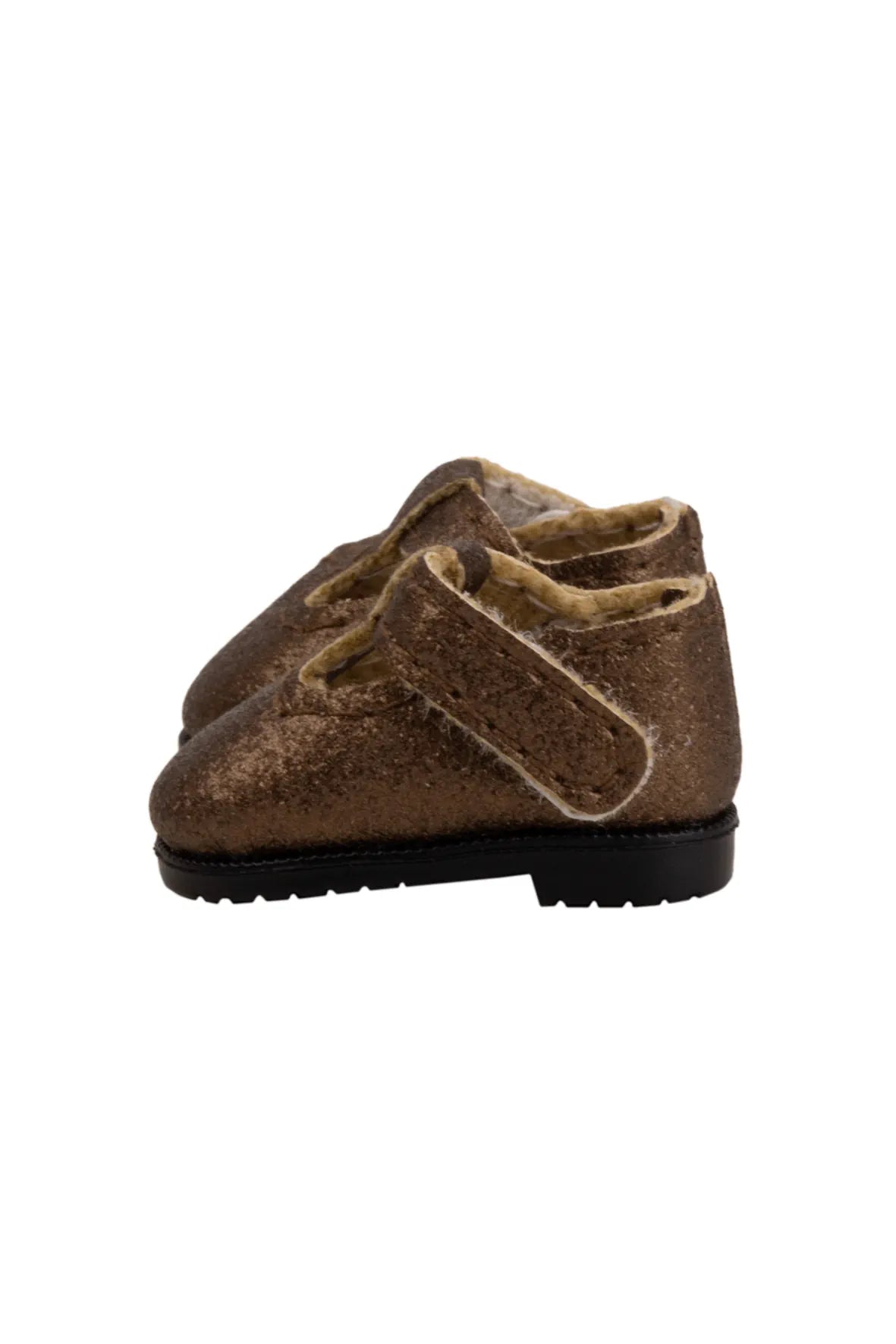 Brown doll shoe with a strap on a white background