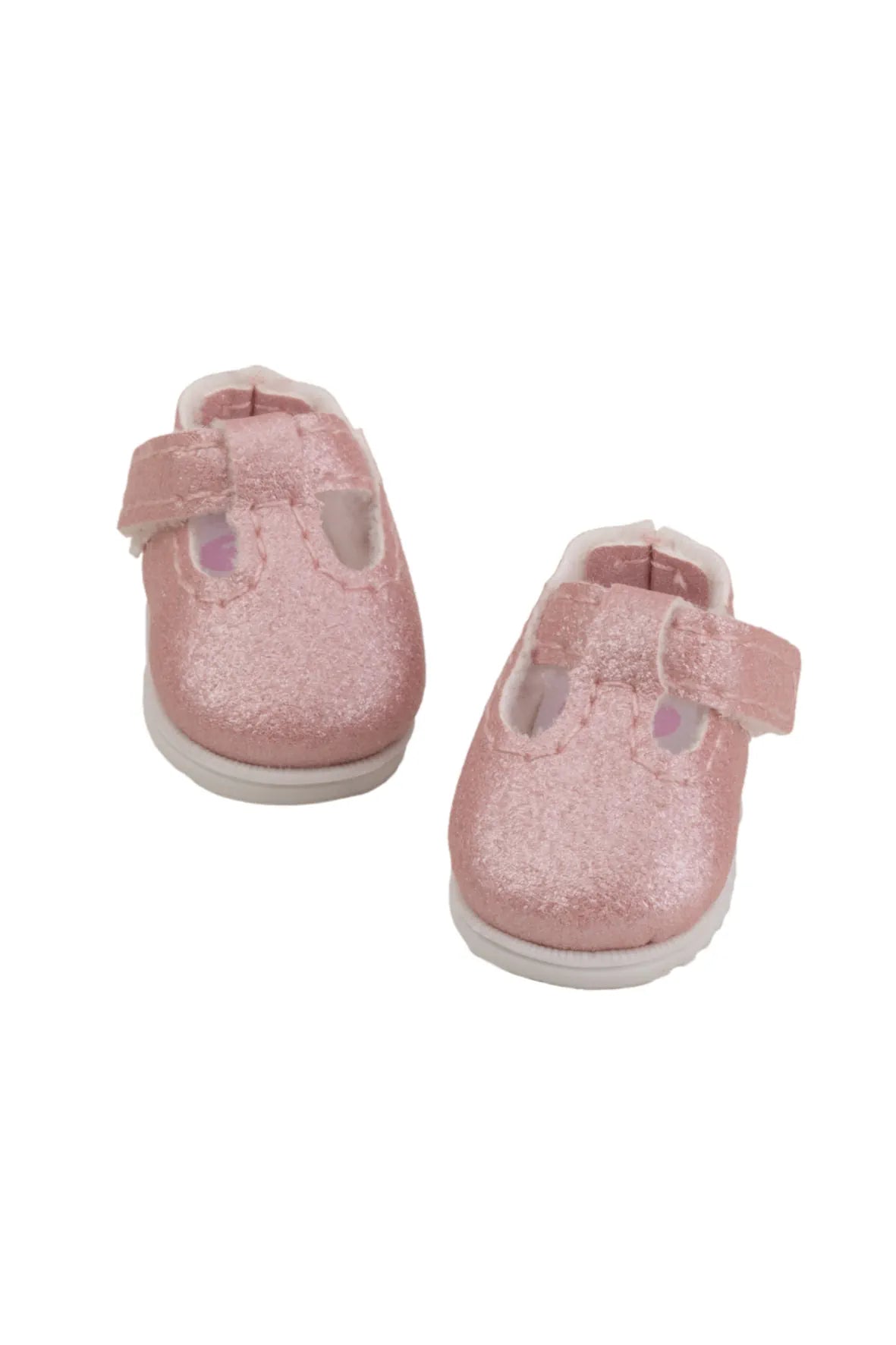 Pair of pink doll shoes on a white background