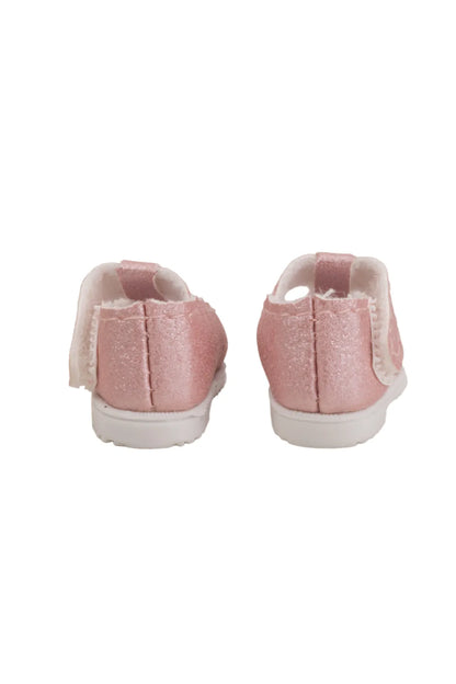 Pair of pink doll shoes back view on a white background