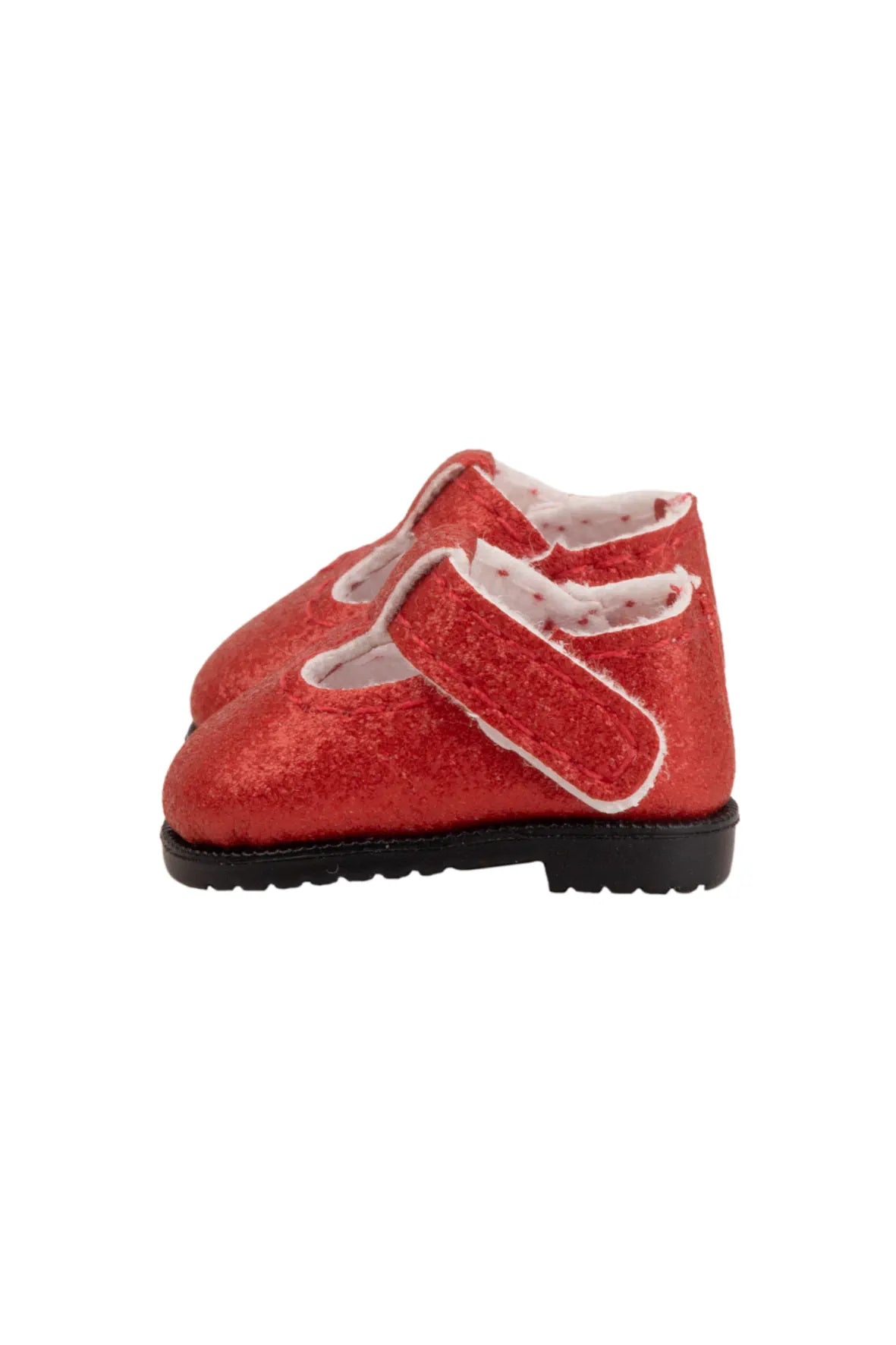 Red doll shoes with white soles on a white background
