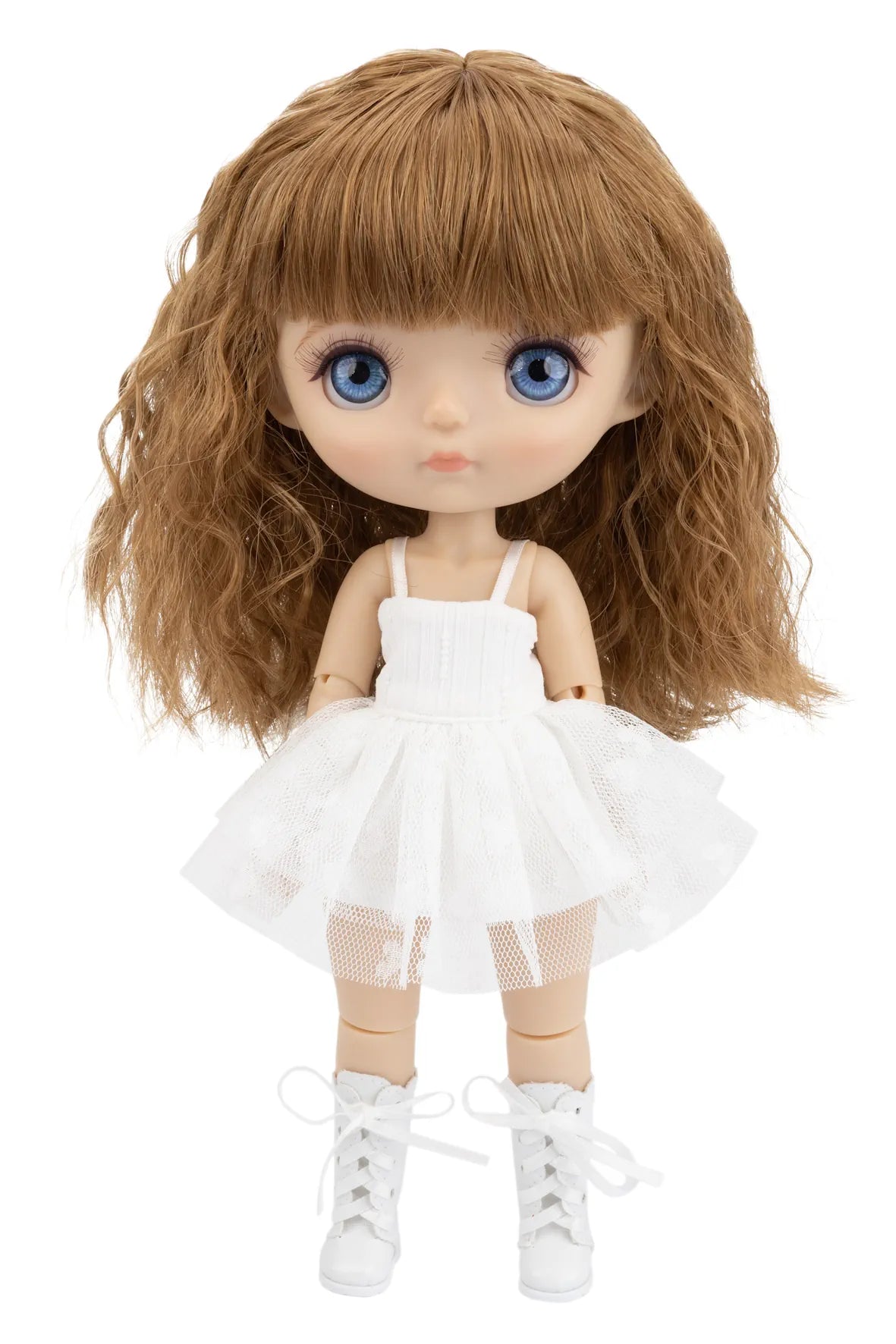 Doll with long blonde hair, blue eyes, and a white dress on a white background