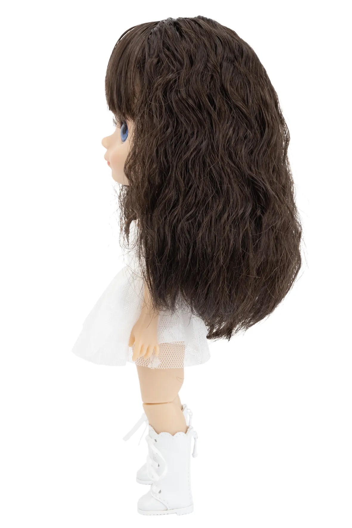 Doll with long dark brown hair on a white background