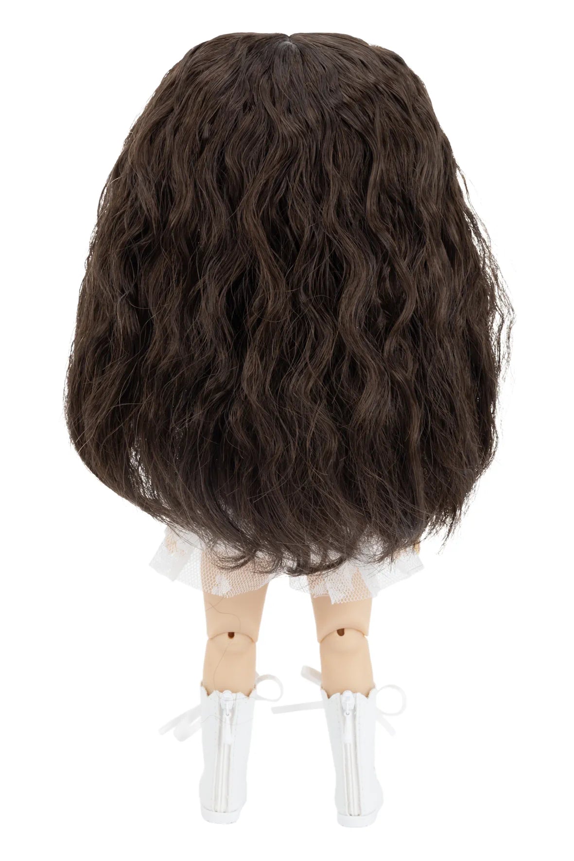 Dark brown wig on a doll head against a white background