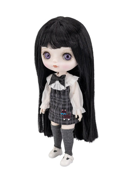A doll with long black hair, large purple eyes, and a dark gray plaid skirt outfit with a white ruffled blouse, black bow, and gray knee socks, shown against a plain white background.