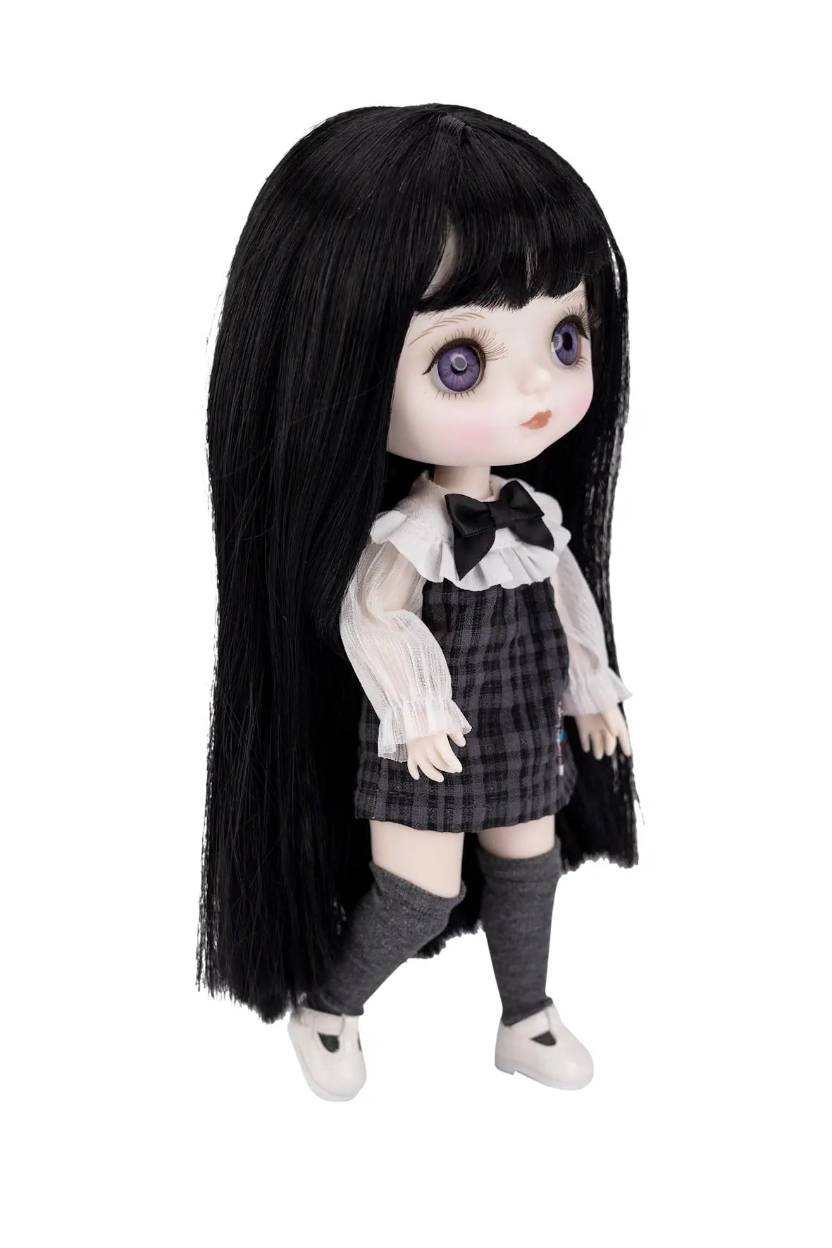 A gothic-style doll with long black hair, large purple eyes, and a black-and-white schoolgirl outfit, shown against a plain white background.