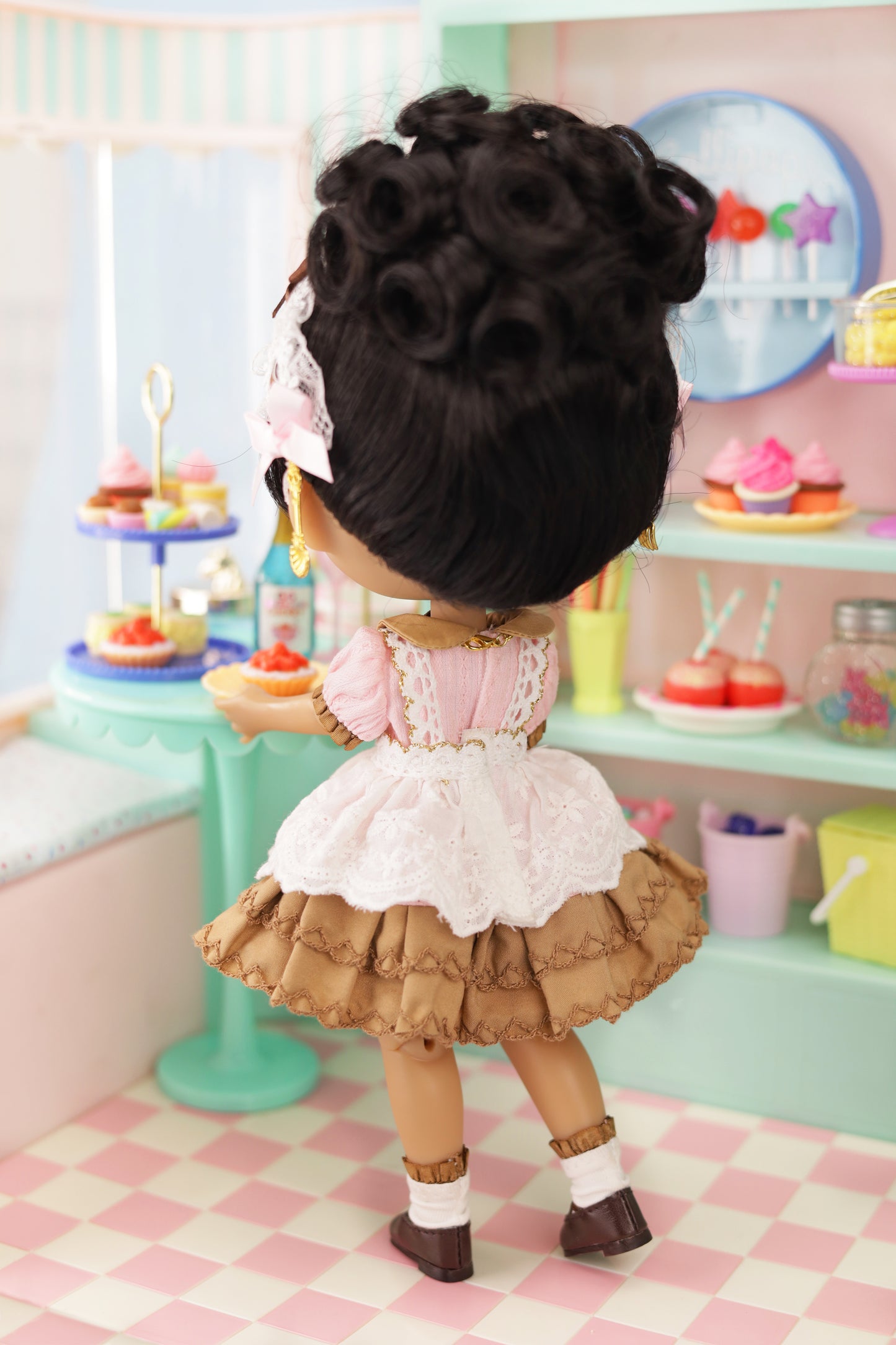 Doll with styled hair in a kitchen setting with pastel colors