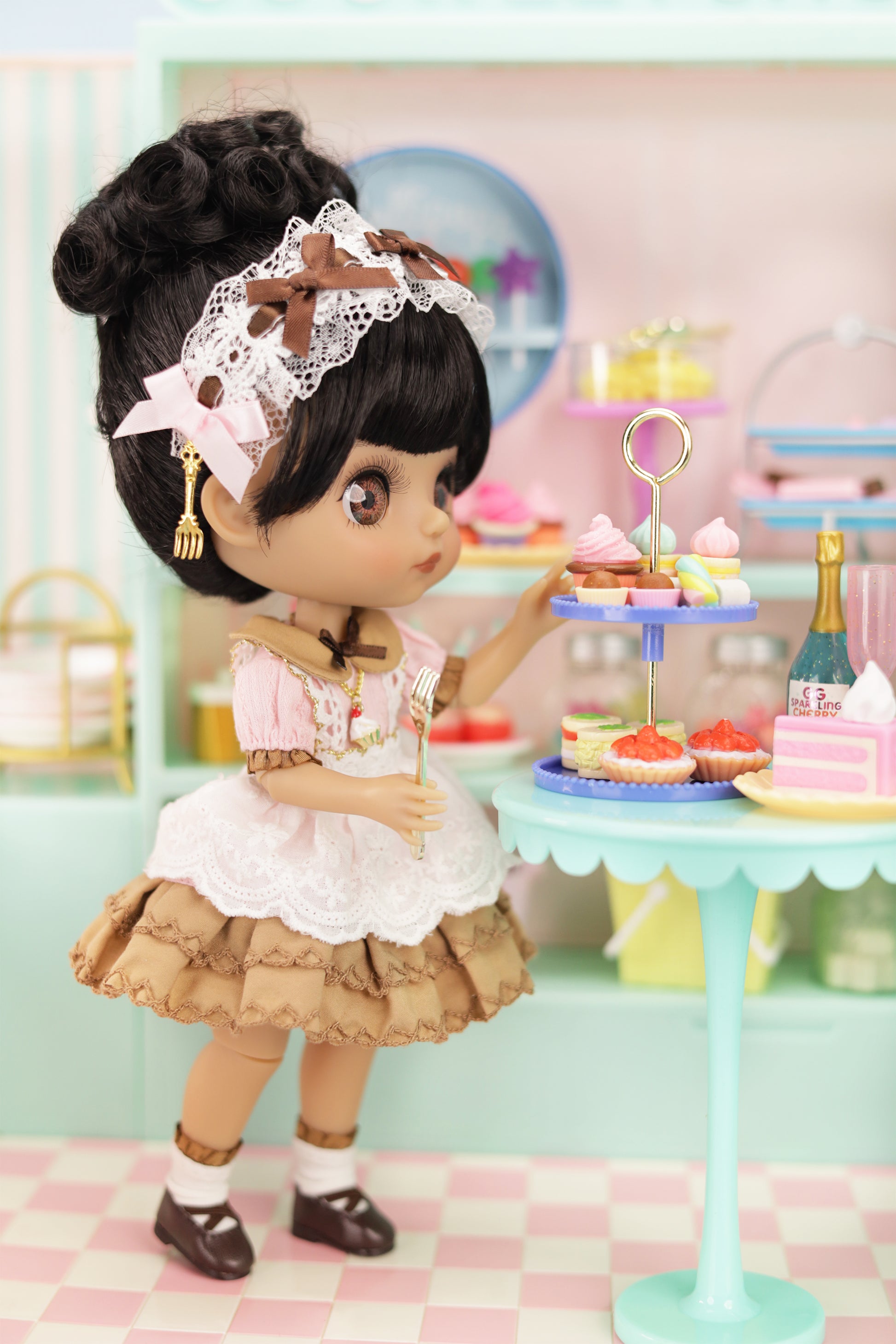 Doll in a vintage outfit with a cake stand in a pastel-colored room