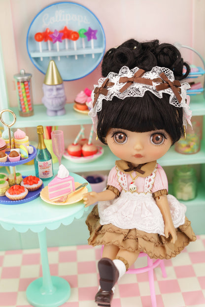 Doll in a vintage setting with a checkered floor and pastel colors.