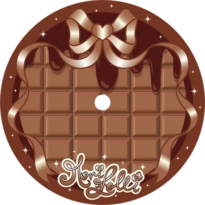 A circular chocolate-themed graphic or label design featuring a milk chocolate bar with a large bow and drizzle at the top.