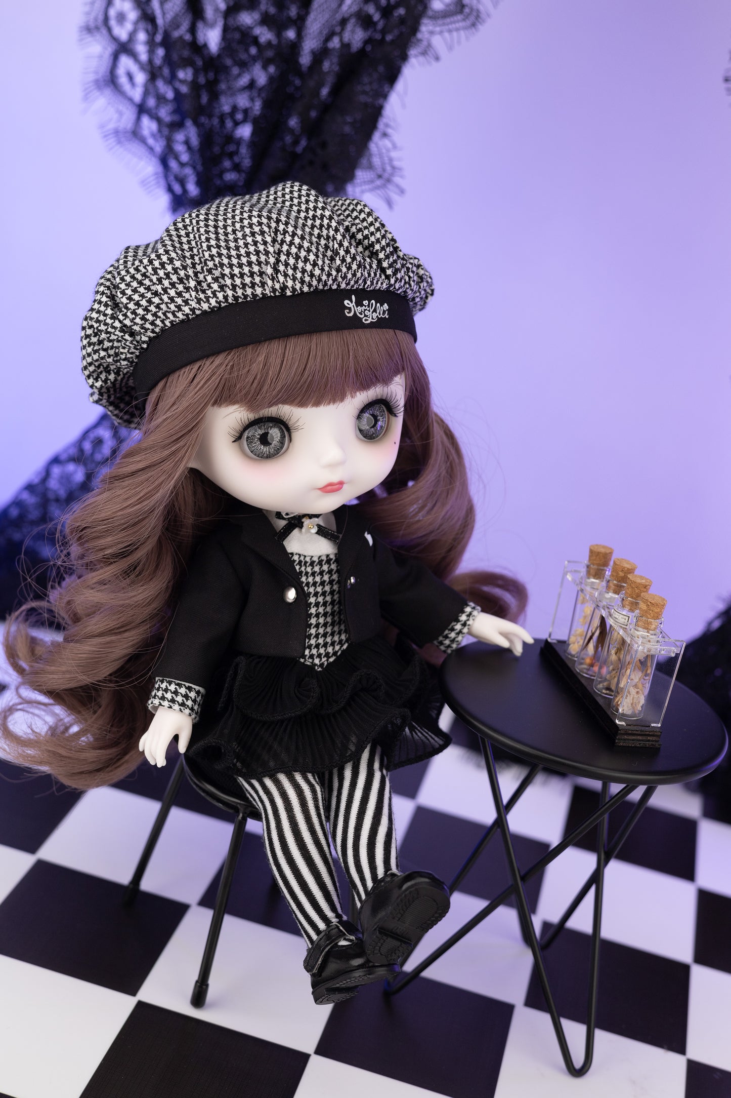Doll with checkered hat and outfit on a checkered floor with a small table.