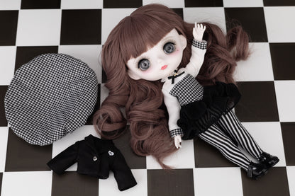  Doll with brown hair and checkered outfit on a black and white checkered floor.
