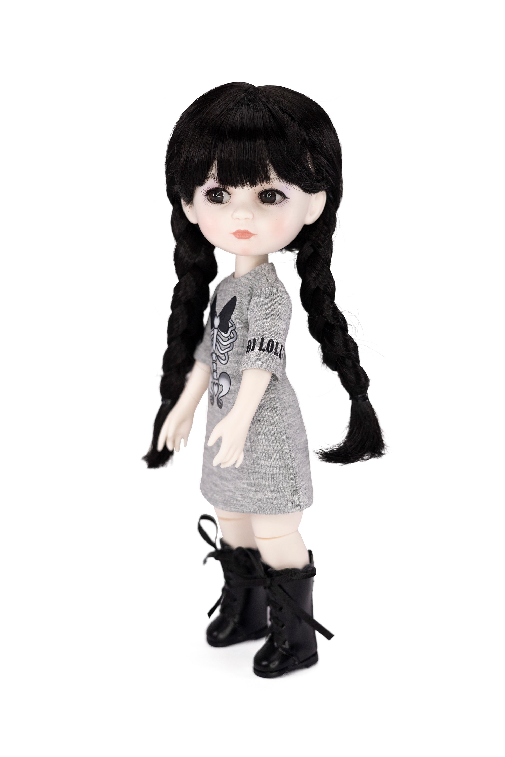 Doll with black hair styled in pigtails, wearing a gray dress and black boots on a white background