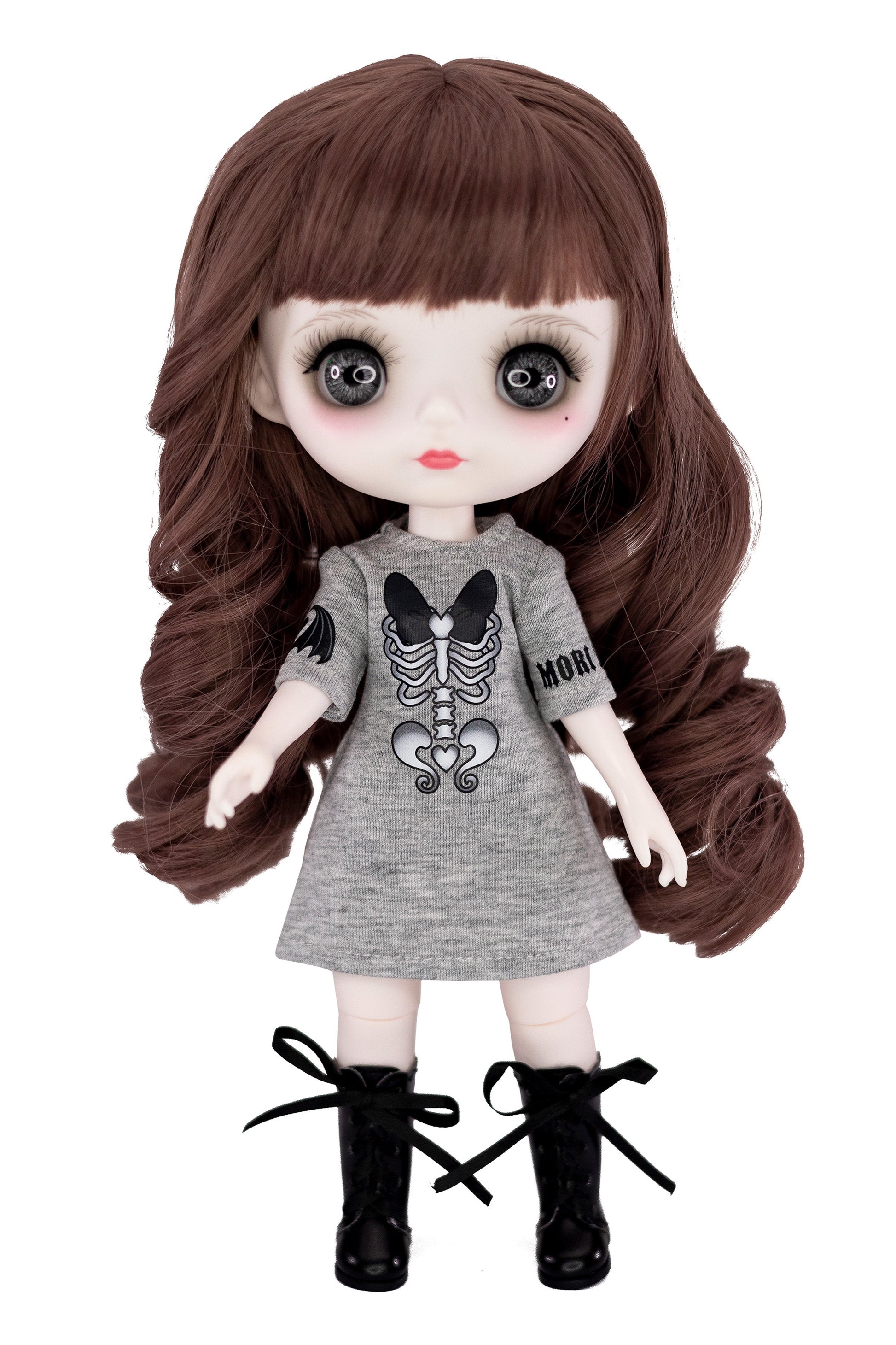 Doll with long brown hair wearing a gray dress with a skeleton design on a white background