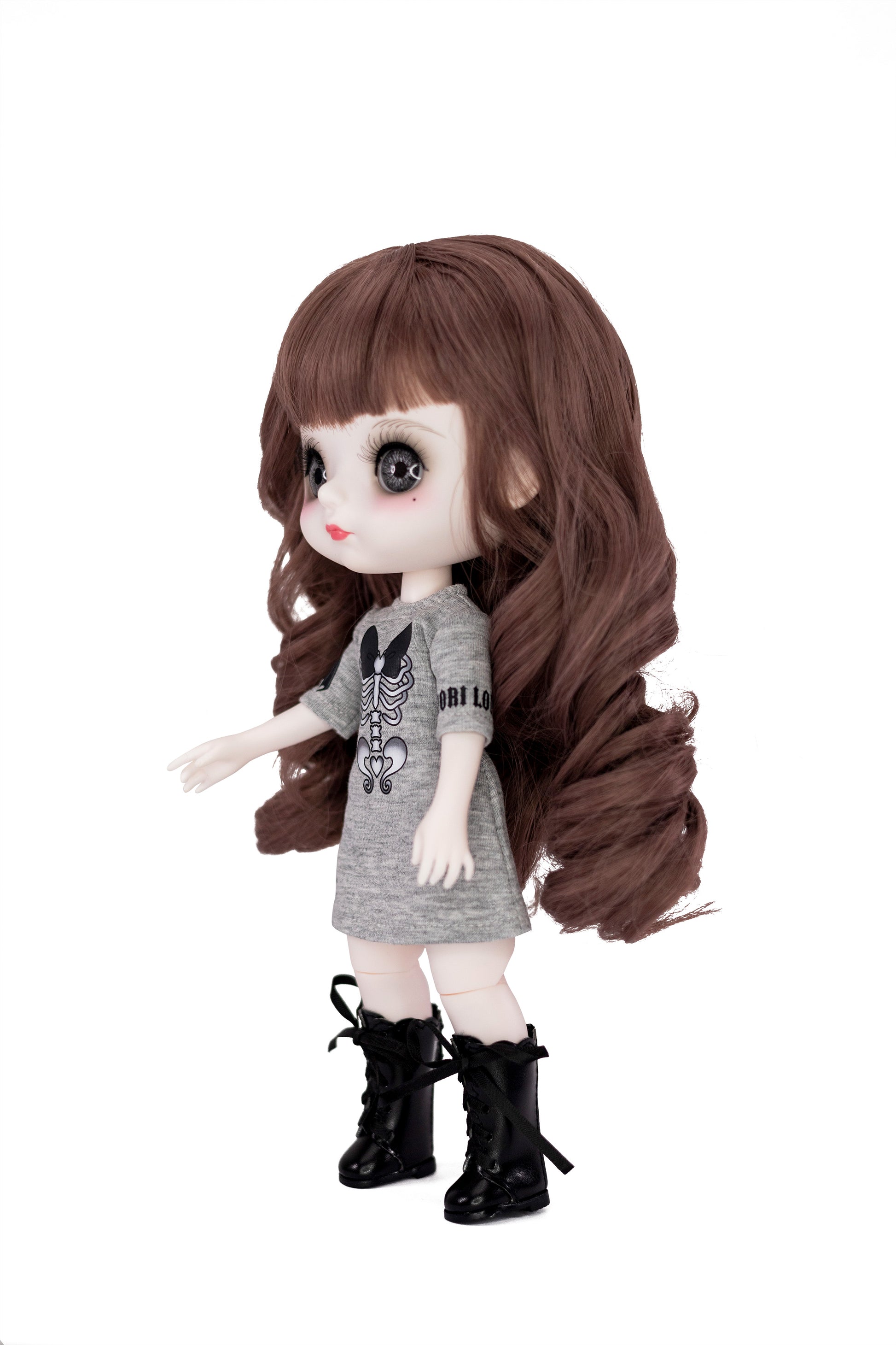 Doll with long brown hair, gray dress, and black boots on a white background