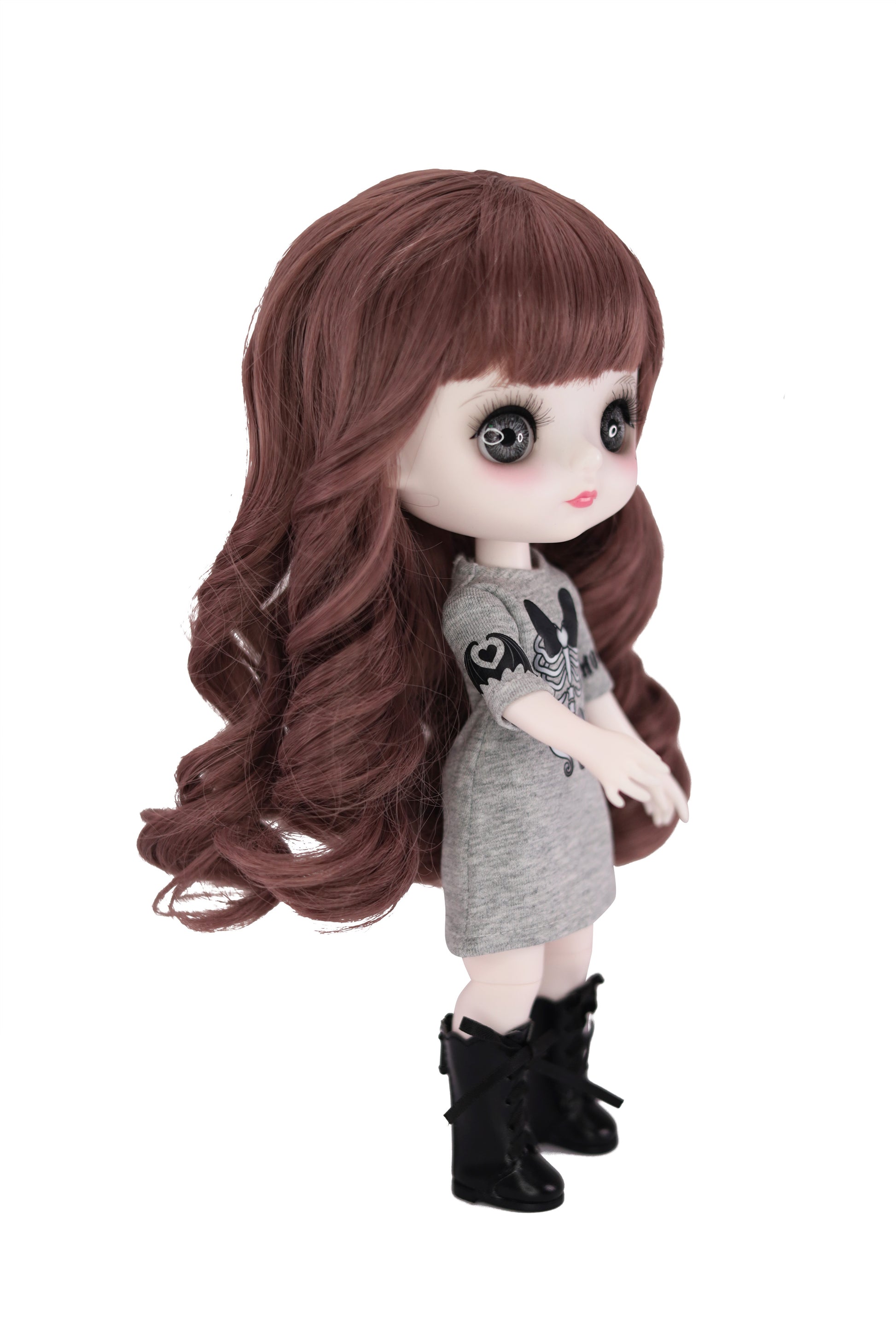 Doll with long brown hair wearing a gray dress and black boots on a white background