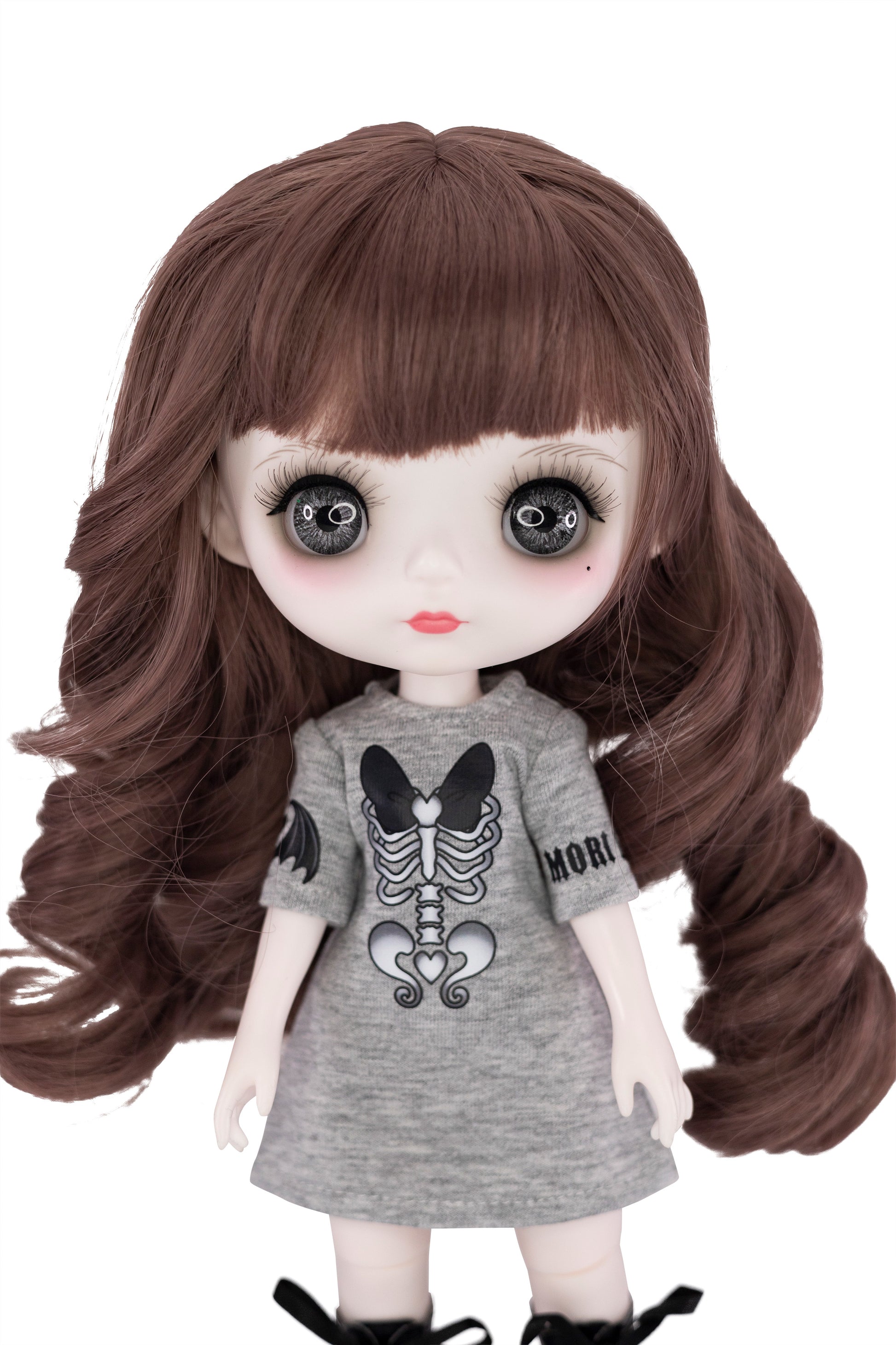 Doll with long brown hair wearing a gray dress with a skeleton design on a white background