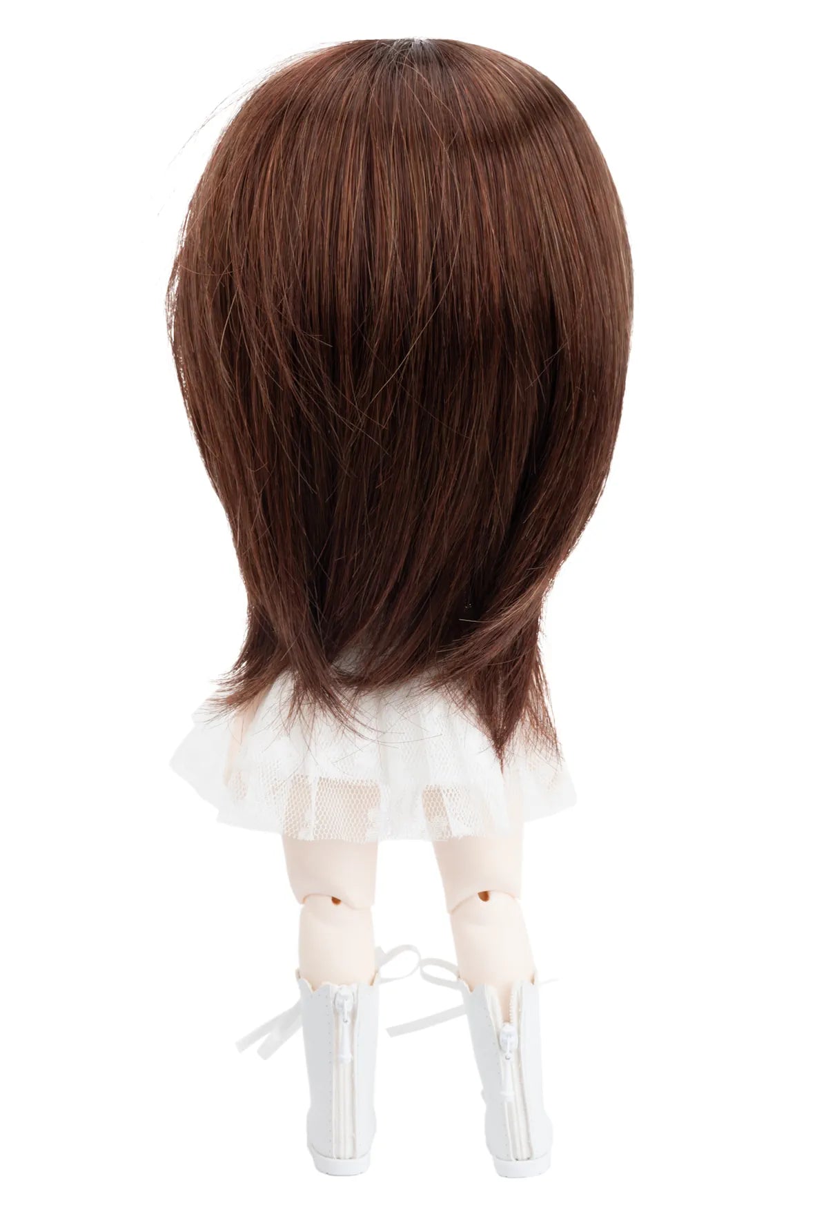 Brown wig on a doll head with a white background
