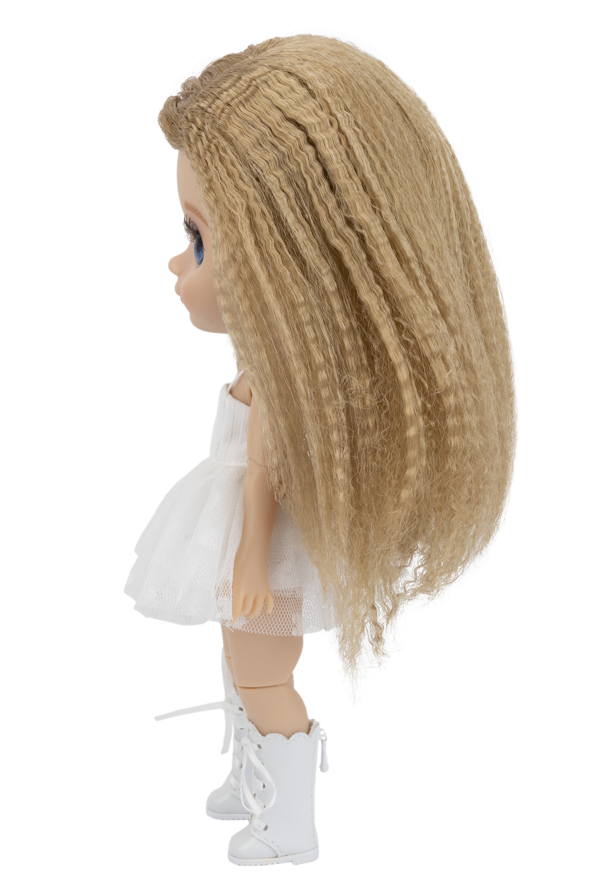 Doll with blonde hair, white dress, and white shoes on a white background