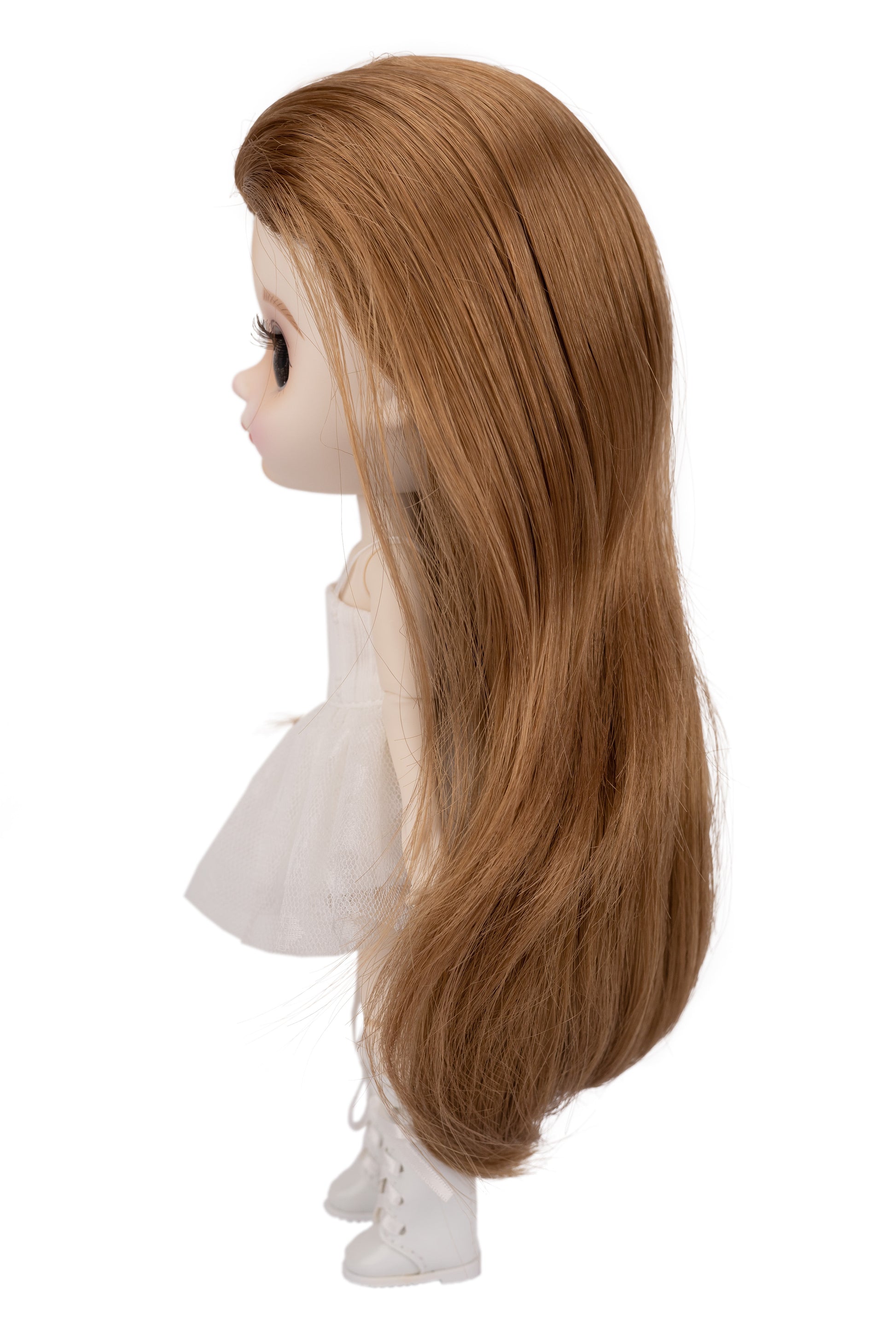 Doll head with long brown hair on a white background