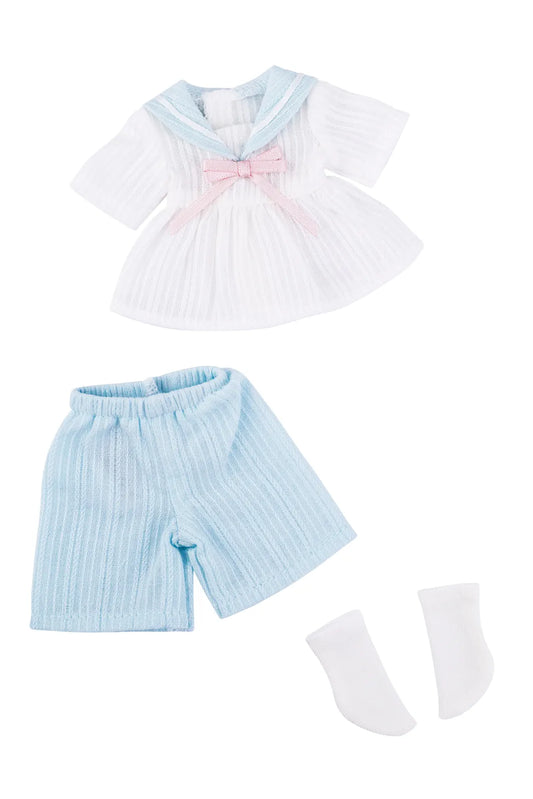 A three-piece doll clothing set featuring a white short-sleeve top with a light blue collar and pink bow, light blue ribbed shorts, and white socks, laid out on a white background.