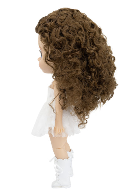 Doll with curly brown hair wearing a white dress and white shoes on a white background