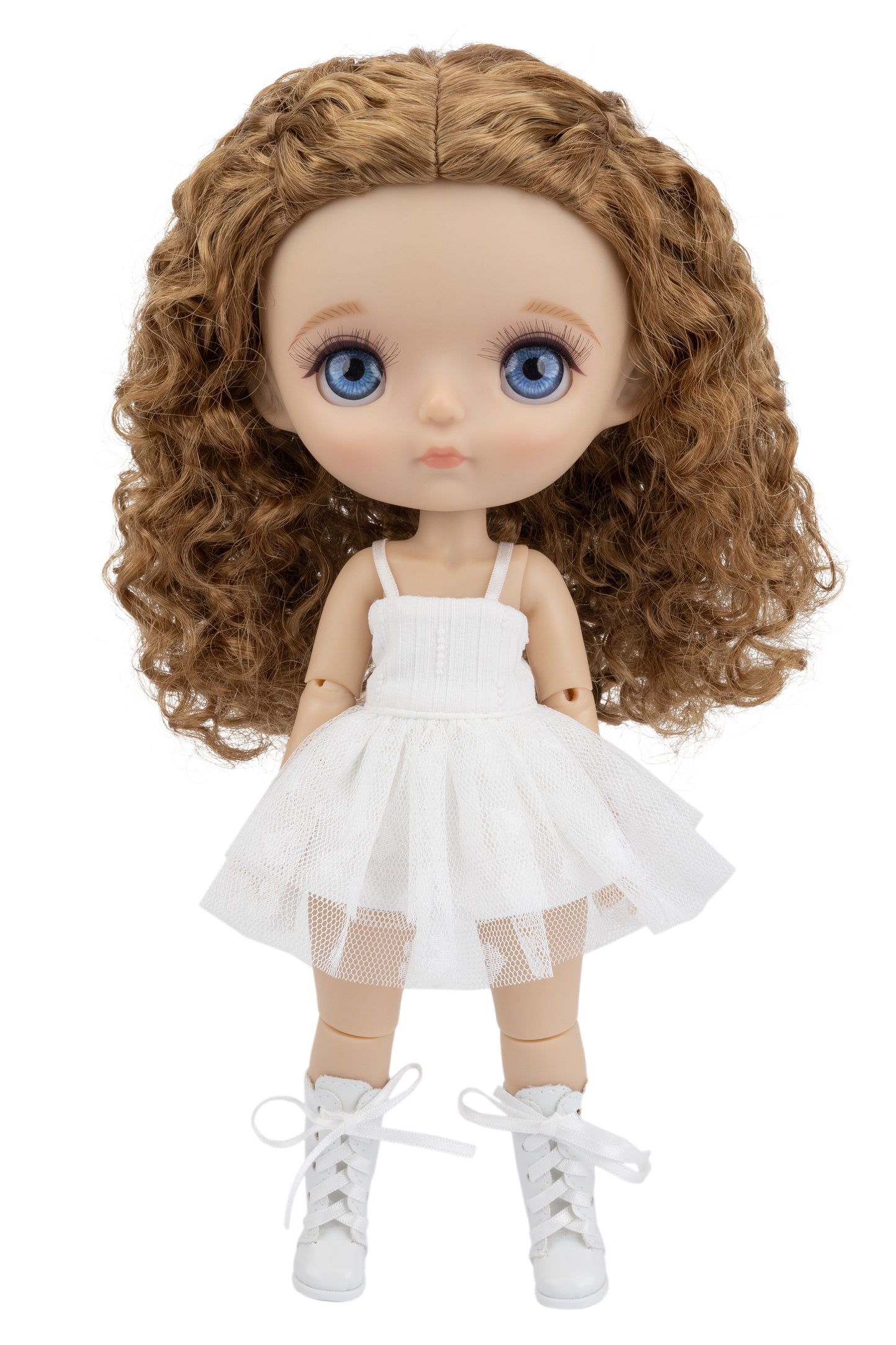 Doll with curly brown hair wearing a white dress on a white background
