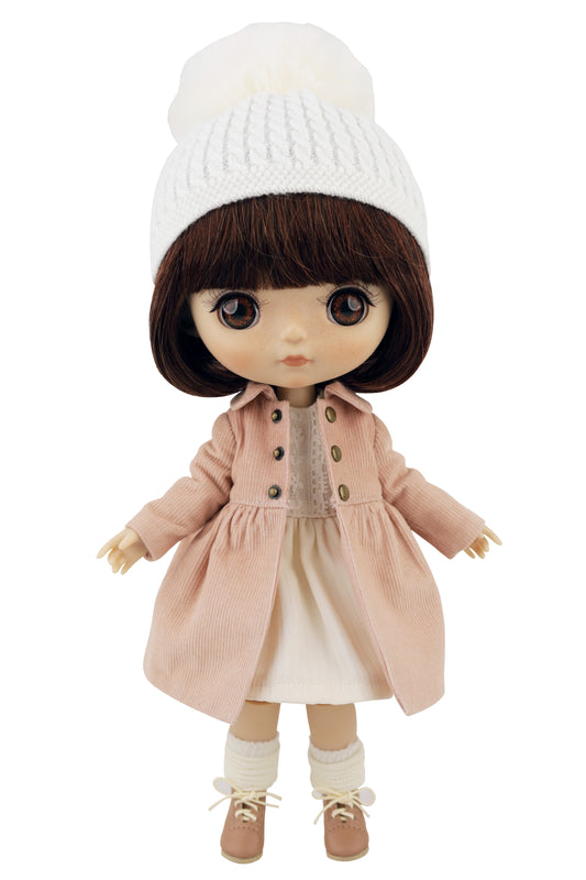 Doll wearing a pink coat, white dress, and white hat on a white background