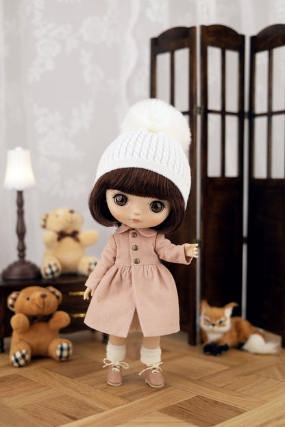 Doll wearing a pink coat and white hat in a room with teddy bears and a fox.