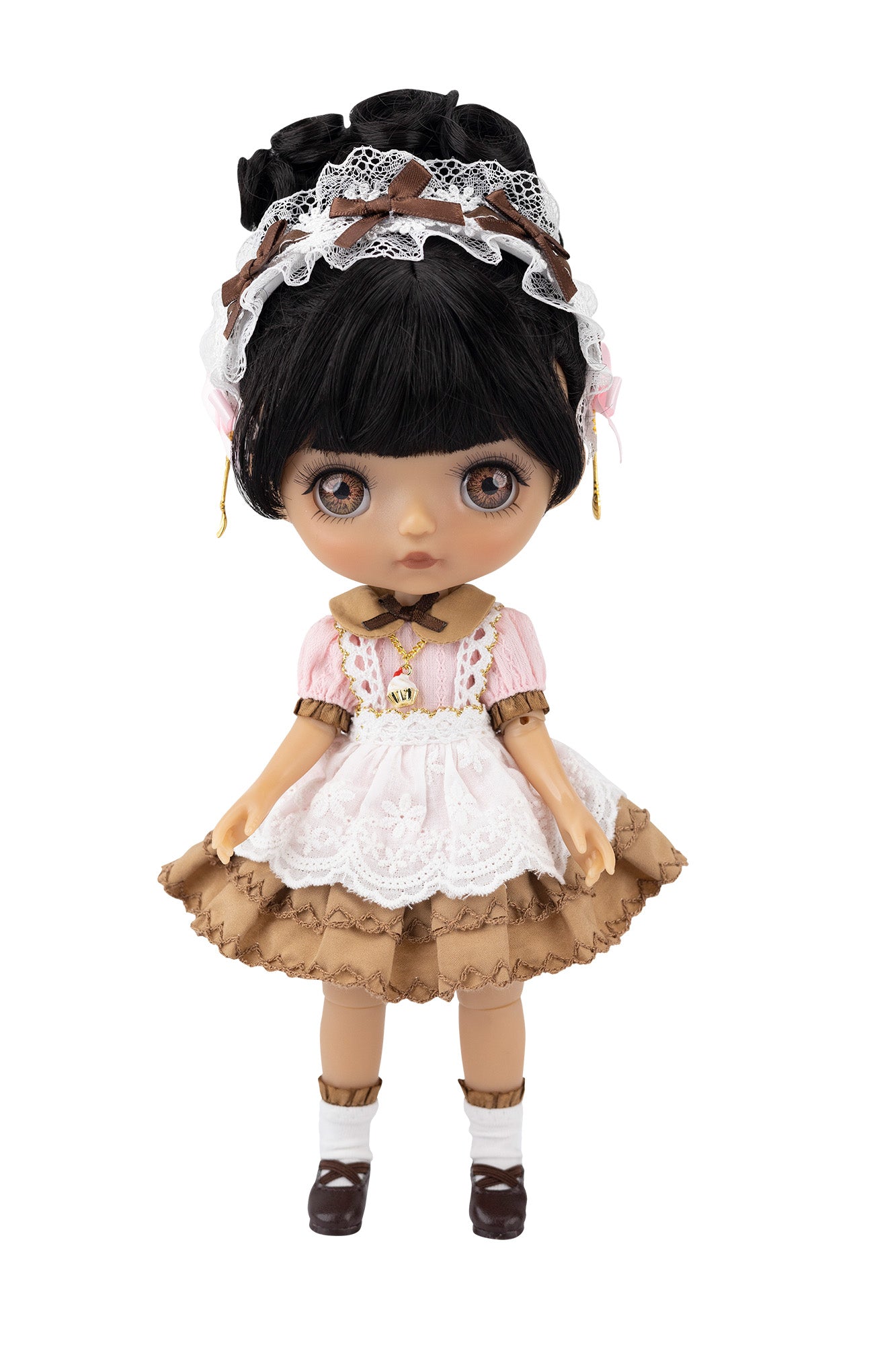 Doll with black hair, lace headband, and vintage-style outfit on a white background