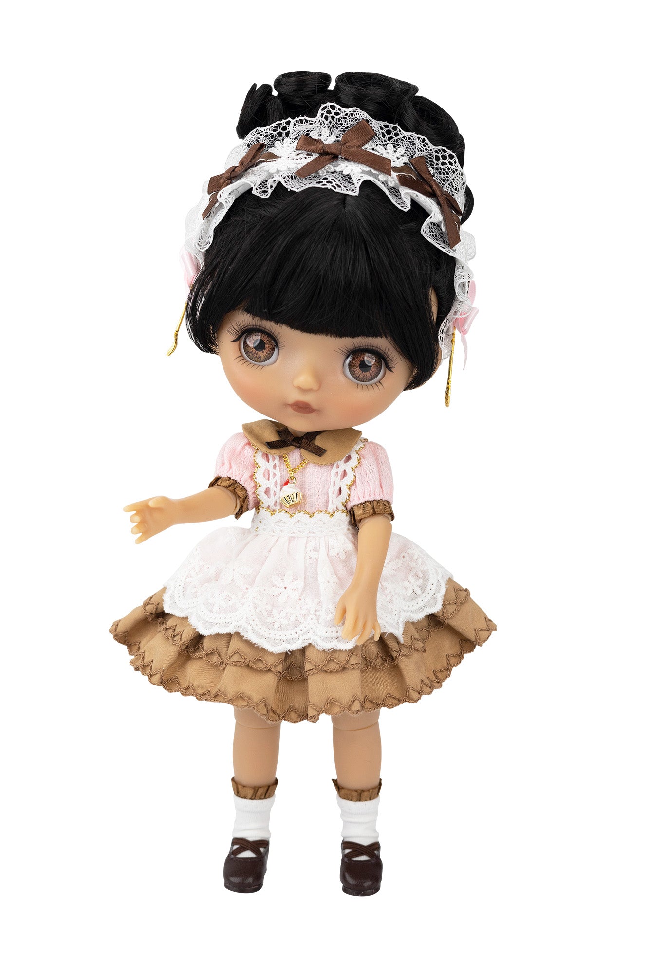 Doll with black hair, lace headband, pink dress, and brown skirt on a white background